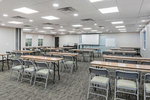 an empty classroom with tables and chairs and a whiteboard at Country Inn & Suites by Radisson, Ashland - Hanover, VA in Ashland