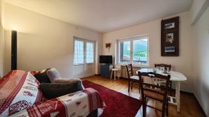 a living room with a couch and a table at Hostdomus - Fox Suite in Sestriere