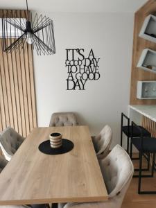 a dining room with a wooden table and chairs at Centar Park Lux in Vrnjačka Banja