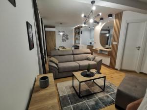 a living room with a couch and a table at Centar Park Lux in Vrnjačka Banja