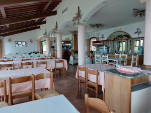 a restaurant with tables and chairs in a room at Bellavista Versilia in Pietrasanta