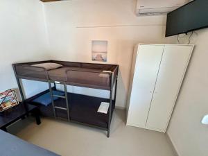 a small room with a bunk bed and a locker at Gregory's Guest House in Stómion +16 photos