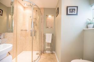 a bathroom with a shower and a sink at Oriel Cottage, Aldeburgh in Aldeburgh +13 photos