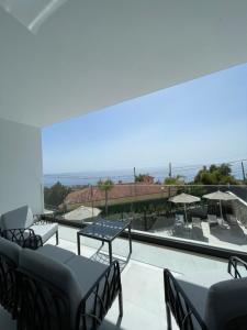 a balcony with chairs and a view of the ocean at Villa27 Dhermi in Dhërmi
