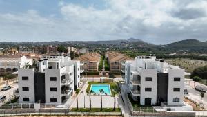 an aerial view of two white buildings with a pool at Apartamentos Arenal 2 in Jávea