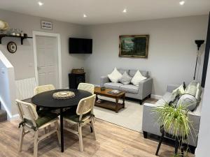 a living room with a table and a couch at The Mourne Hideaway in Annalong