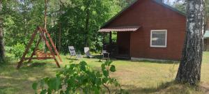 a house with a playground and a swing at Domki Nad Tanwią in Susiec +83 photos