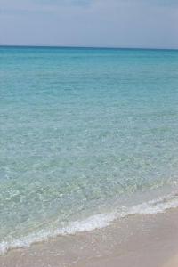 a view of the ocean with the sand and water at UGENTOMARINA 2026 TORRE SAN GIOVANNI 50metri dal mare in Torre San Giovanni Ugento