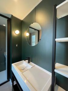 a bathroom with a sink and a mirror at Camping Canal de Berry in Saint-Amand-Montrond +52 photos