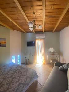a bedroom with a bed and a wooden ceiling at Stefanos house in Parga