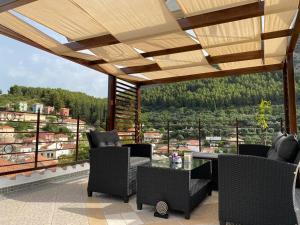 a patio with chairs and a table with a view at Stefanos house in Parga
