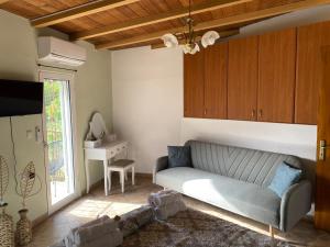 a living room with a couch and a table at Stefanos house in Parga