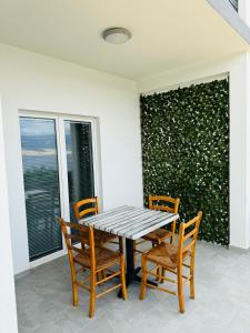a wooden table and chairs on a patio at Apartment Ivanka in Pag