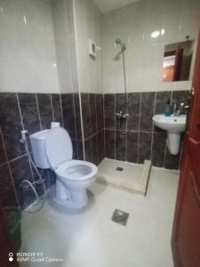 a bathroom with a toilet and a sink at Farah Plaza Hostel &Hotel Apartments in Aqaba +88 photos
