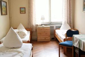 a hospital room with two beds and a chair at Haus Annaberg in Bonn