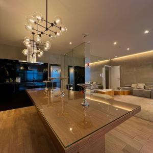 a kitchen with a table with wine glasses on it at Studio Prime 920 - IS Moema in Sao Paulo