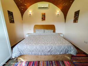 a bedroom with a large bed in a room at Sahure Pyramid View Inn in Cairo