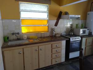a small kitchen with a sink and a stove at La casita Libertad en San Miguel del Monte in San Miguel del Monte +10 photos