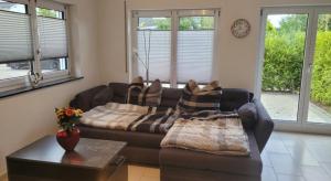 a living room with a couch and a table at Fewo Huber in Bad Waldsee