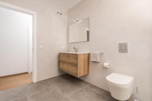 a bathroom with a white toilet and a sink at Aparto Almi in Moraira +35 photos