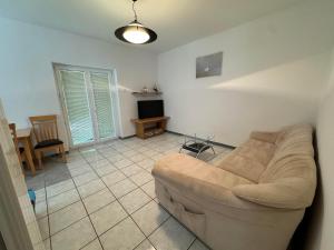 a living room with a couch and a tv at Apartment Ivanka in Pag