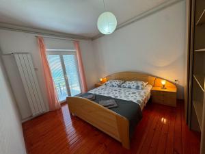 a bedroom with a bed and a large window at Apartment Ivanka in Pag +38 photos