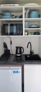 a kitchen counter with a sink and a microwave at Garden House in Pruszcz Gdański +16 photos