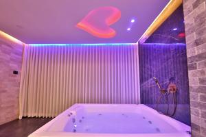 a bathroom with a tub with a heart on the ceiling at שקיעות אדומות in Haifa