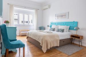 a bedroom with a blue bed and a blue chair at Casa da Avenida Lisboa in Lisbon