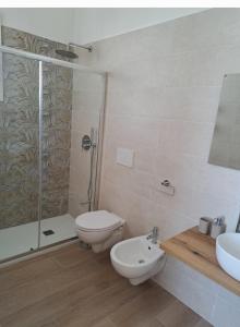 a bathroom with a shower and a toilet and a sink at HOUSE Apartment in Torre Squillace