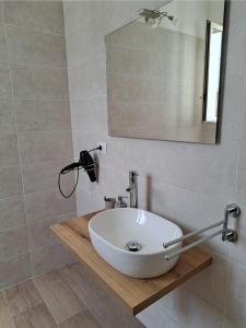 a bathroom with a white sink and a mirror at HOUSE Apartment in Torre Squillace
