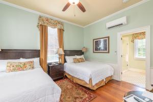 a bedroom with two beds and a window at The Beaufort Inn in Beaufort