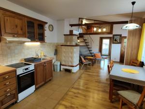 a kitchen and living room with a stove top oven at Apartment My Way in Poprad