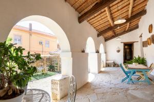an outdoor patio with an archway and a table at Bissantica, heritage and charm in rural Sardinia in Lunamatrona