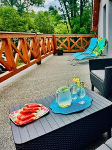 a table with a tray of food and drinks on a deck at Apartament Rodzinny w Goszowie in Stronie Śląskie +7 photos
