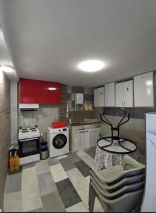 a kitchen with white cabinets and a table and chairs at комната с отдельным входом in Baošići