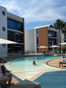 a woman swimming in a swimming pool in a building at SoBlue Hôtel in Antibes