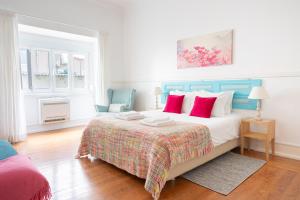 a bedroom with a large bed with red pillows at Casa da Avenida Lisboa in Lisbon