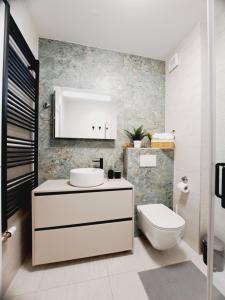 a bathroom with a white sink and a toilet at Apartment CityAna - private garage, 0-24 Self Check In in Zagreb +72 photos