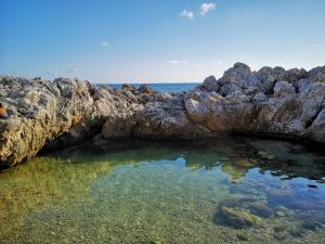 a pool of water next to some rocks at Villa il Faro - Circeo holiday house in San Felice Circeo