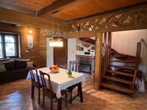 a kitchen and dining room with a table and chairs at Chata Wetłyna I in Wetlina