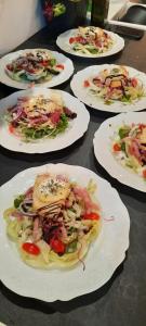 a group of plates of food on a table at L'EAU QUI DORT - Chambres et Tables d'hôtes in Pleslin-Trigavou +53 photos