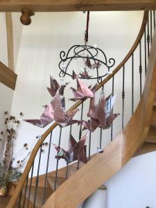a chandelier with paper butterflies on the stairs at Poulou Pyrénées in Gelos
