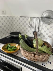 a basket of vegetables sitting on top of a stove at Dimora Storica Villa Pasquale Capri in Capri