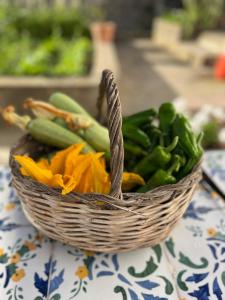 a basket of vegetables sitting on a table at Dimora Storica Villa Pasquale Capri in Capri