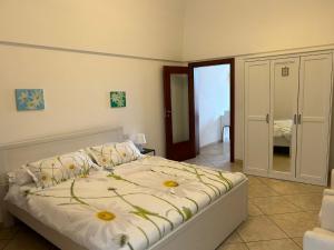 a bedroom with a bed with flowers on it at B&B Margherita in Putignano