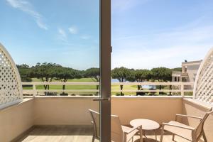 a balcony with chairs and a view of the ocean at Onyria Quinta da Marinha Hotel in Cascais