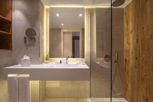 a bathroom with a sink and a shower at Onyria Quinta da Marinha Hotel in Cascais