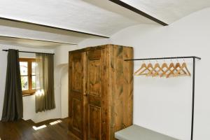 a room with a wooden cabinet and a window at Apartments Mitterhof 1544 in Brunico