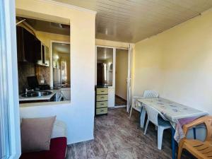 a kitchen and dining room with a table and chairs at Cozy Flat N2 in Ureki